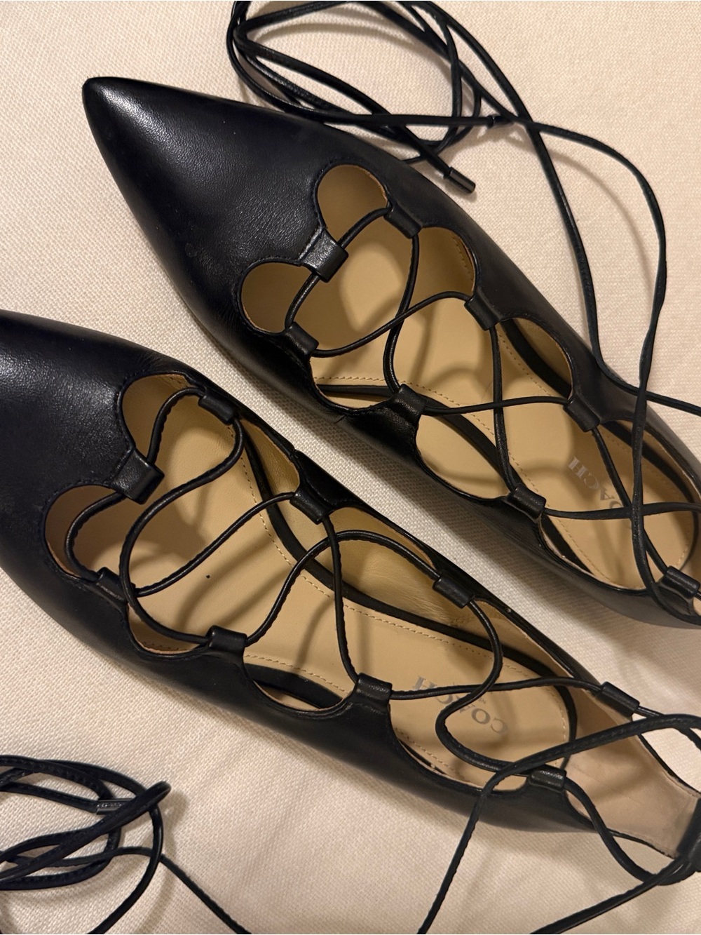 Add some edge to your look with these Coach Black Pointed-Toe Lace-Up Flats